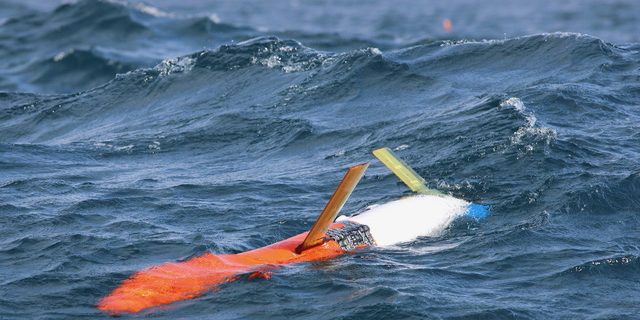 Glider Deploymnet April 2025 Credit Robert Todd Orange and white spray 2 glider on the ocean surface